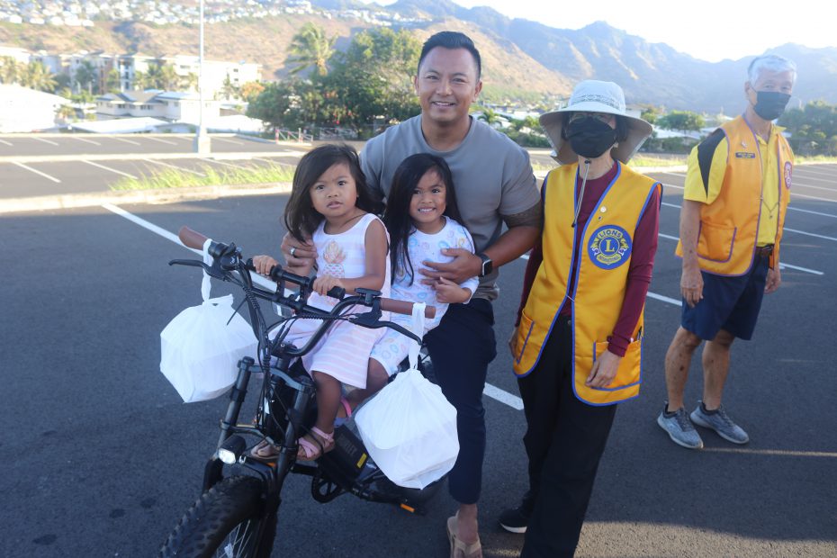 Father & 2 daughters on bicycle