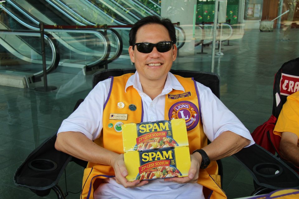 PDG Chris Tamura holding cans of Spam